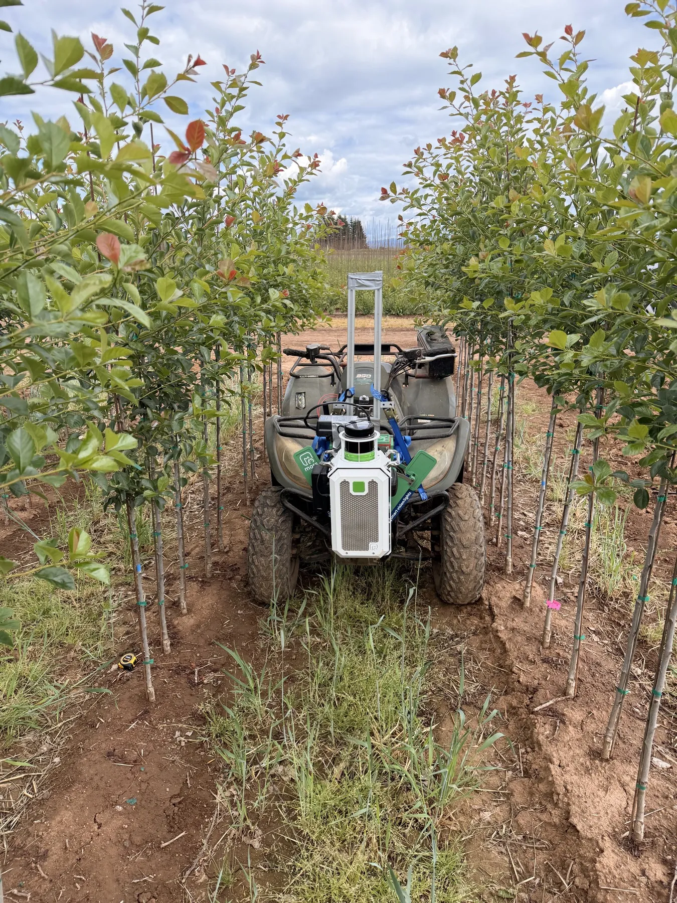 The moss kit mounted on an ATV between nursery rows